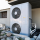 The external fan box of a geothermal heat pump system on the side of a building.